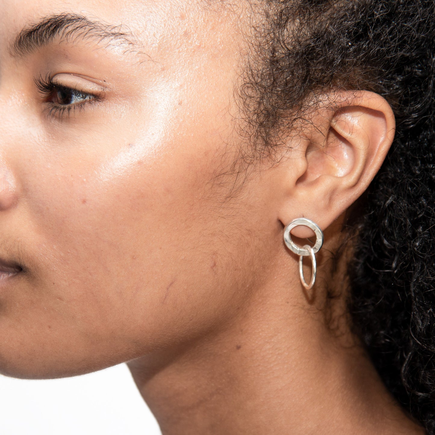 An up-close picture of Ruby wearing the contrasting hoops.