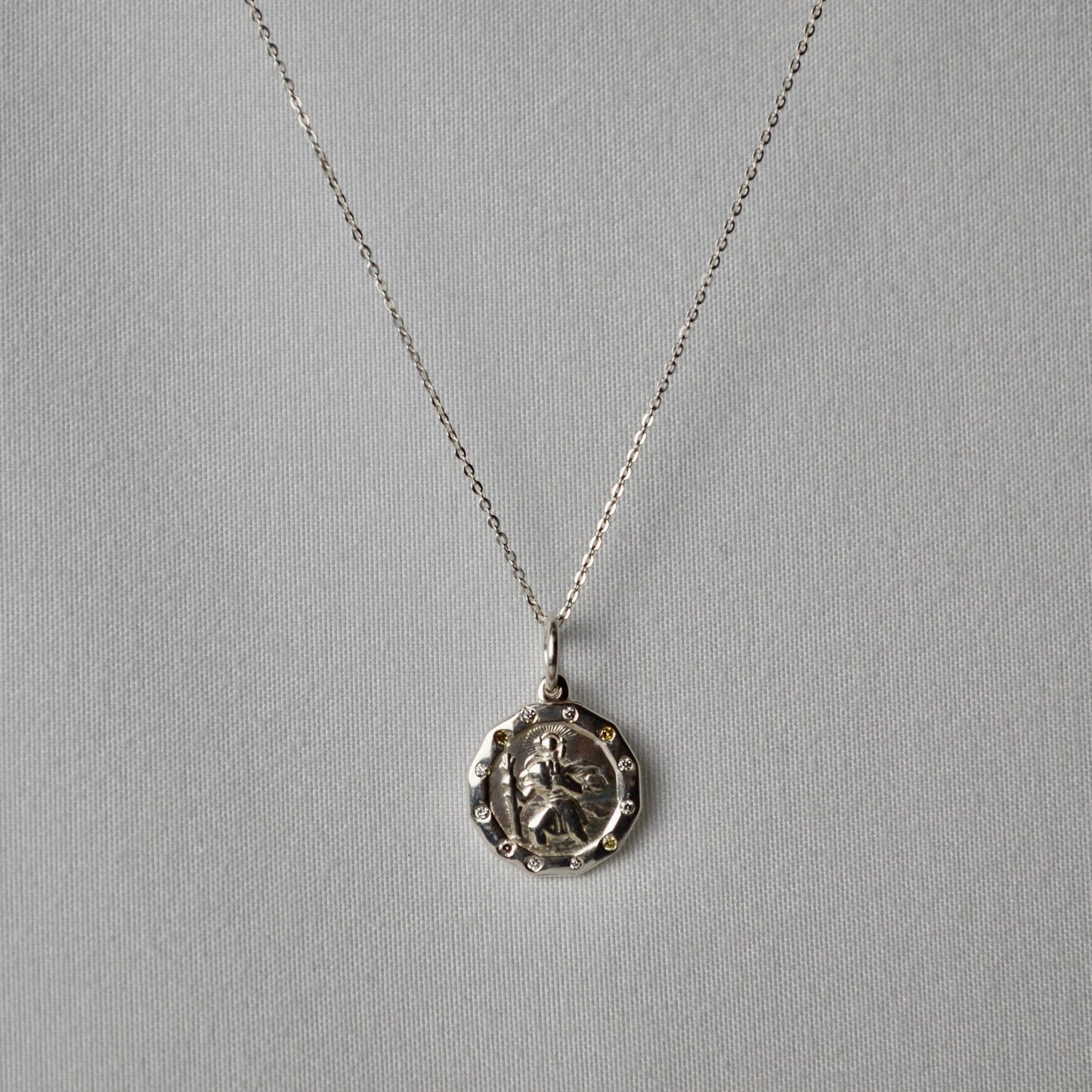 Silver necklace with a pendant on a gray background