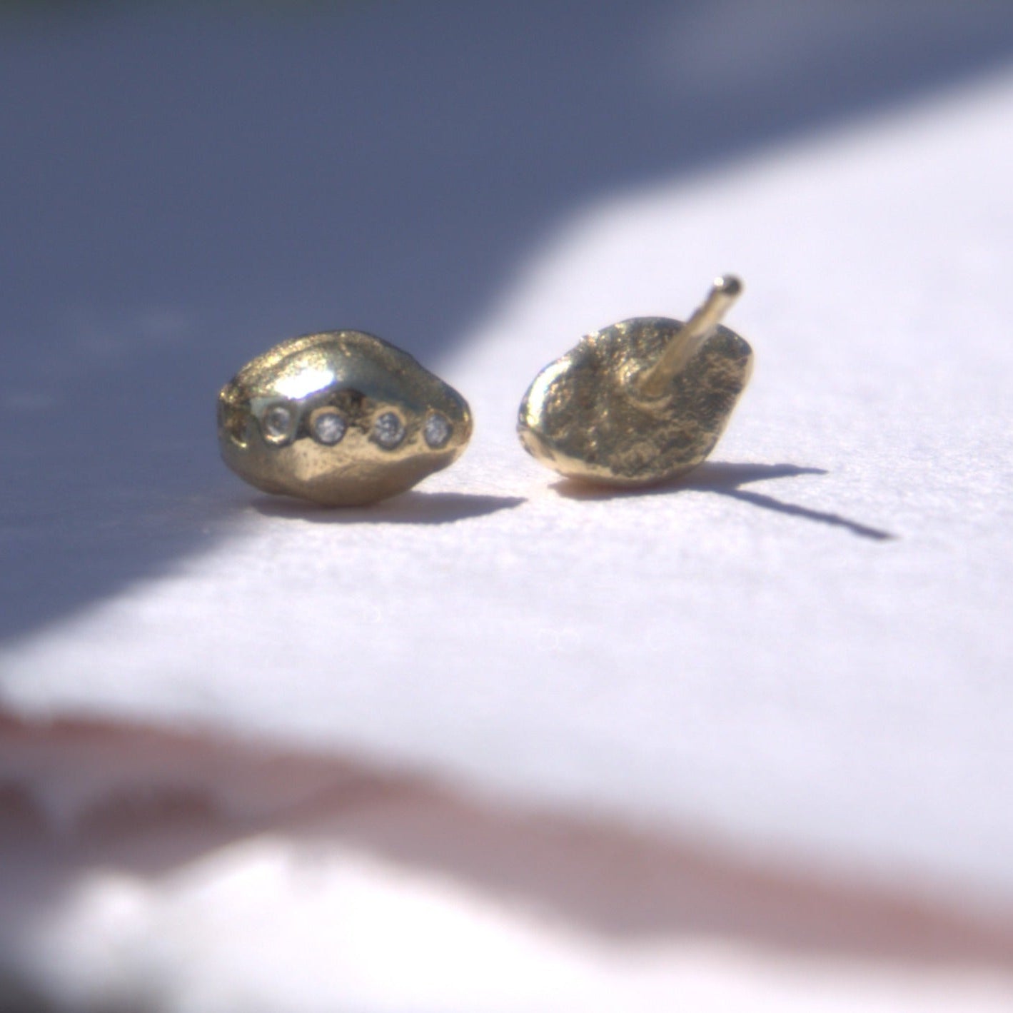 diamond gold studs pictured on natural white background, handmade fine jewellery by Madeleine.