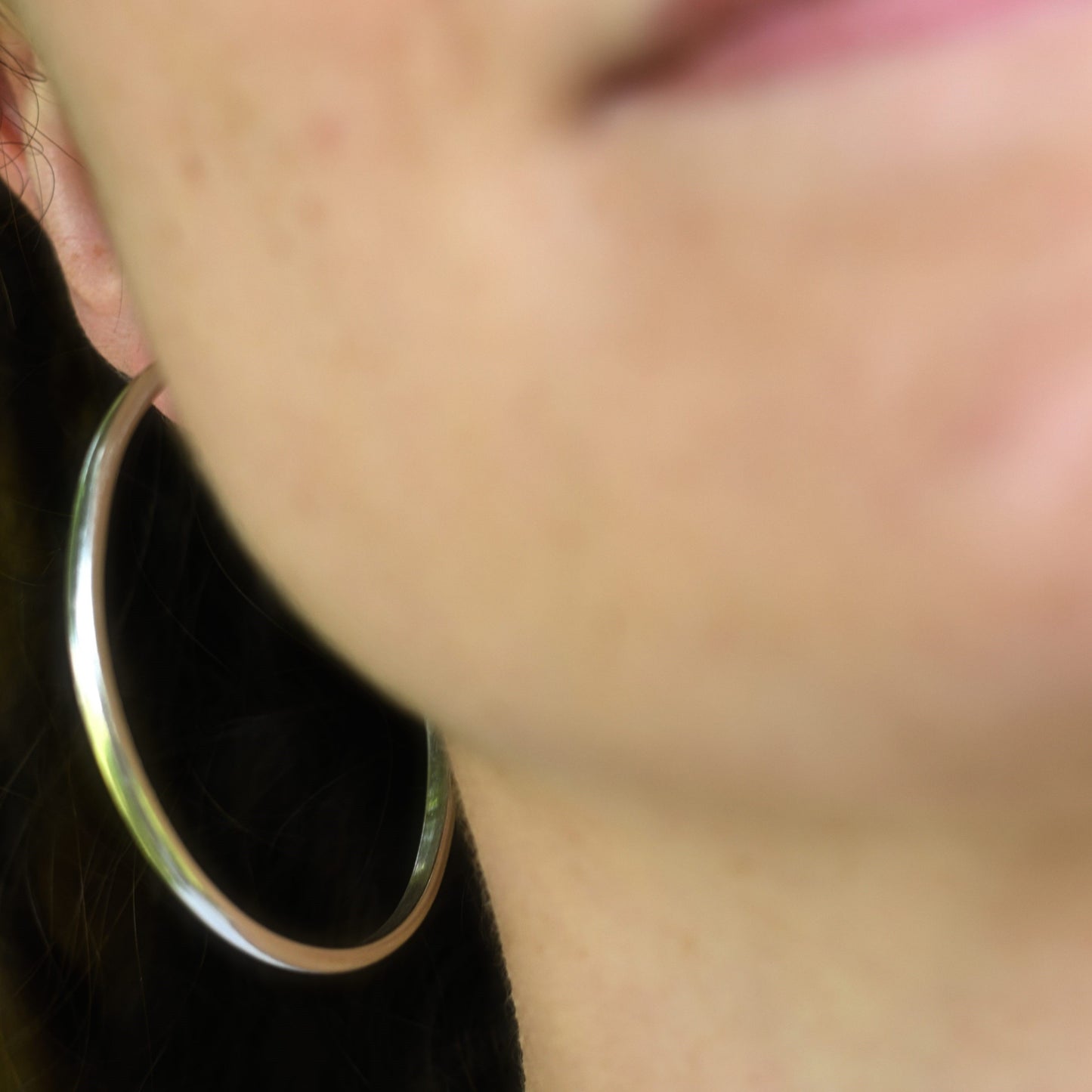 Maddy wearing the classic silver hoops in the cotswolds.