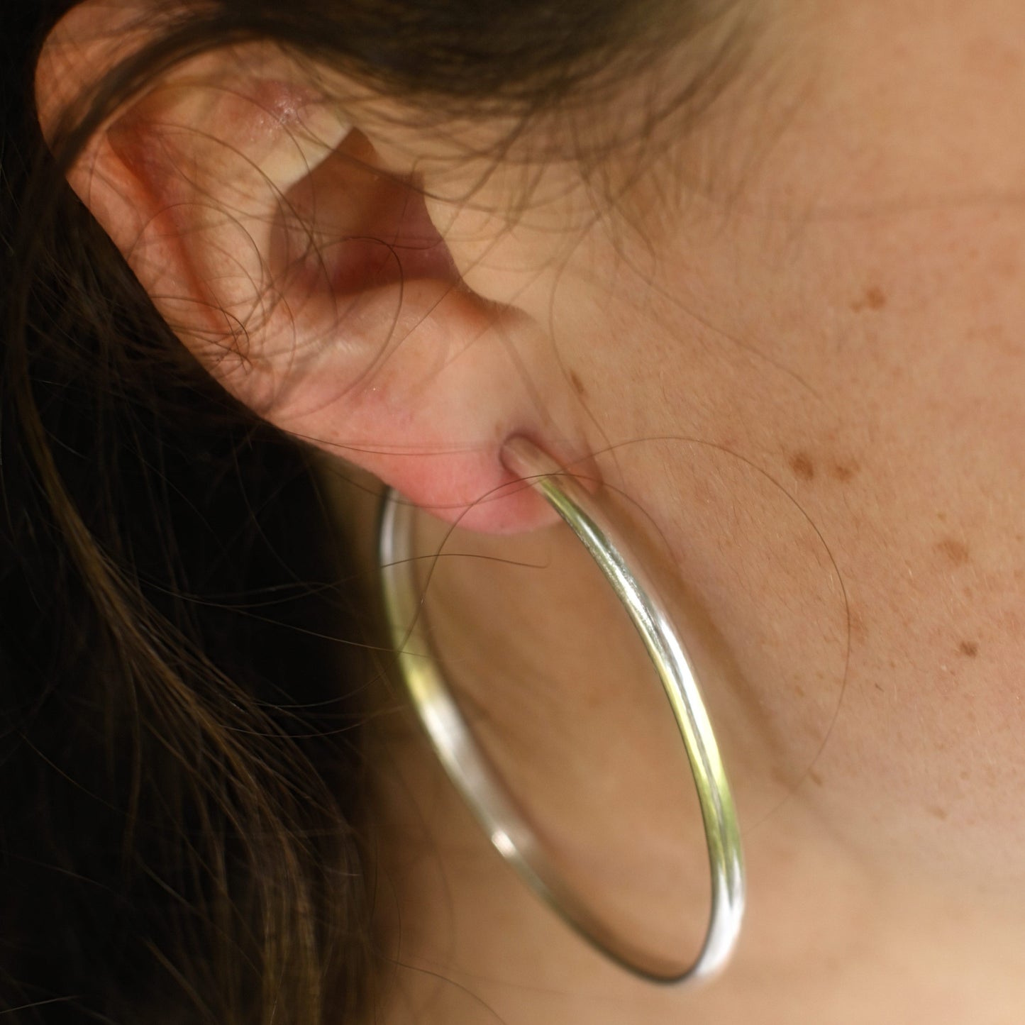 Maddy wearing the classic silver hoops.