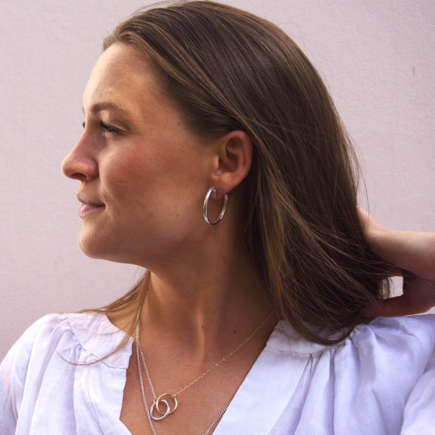 Katie wearing the handmade sterling silver curved hoops.