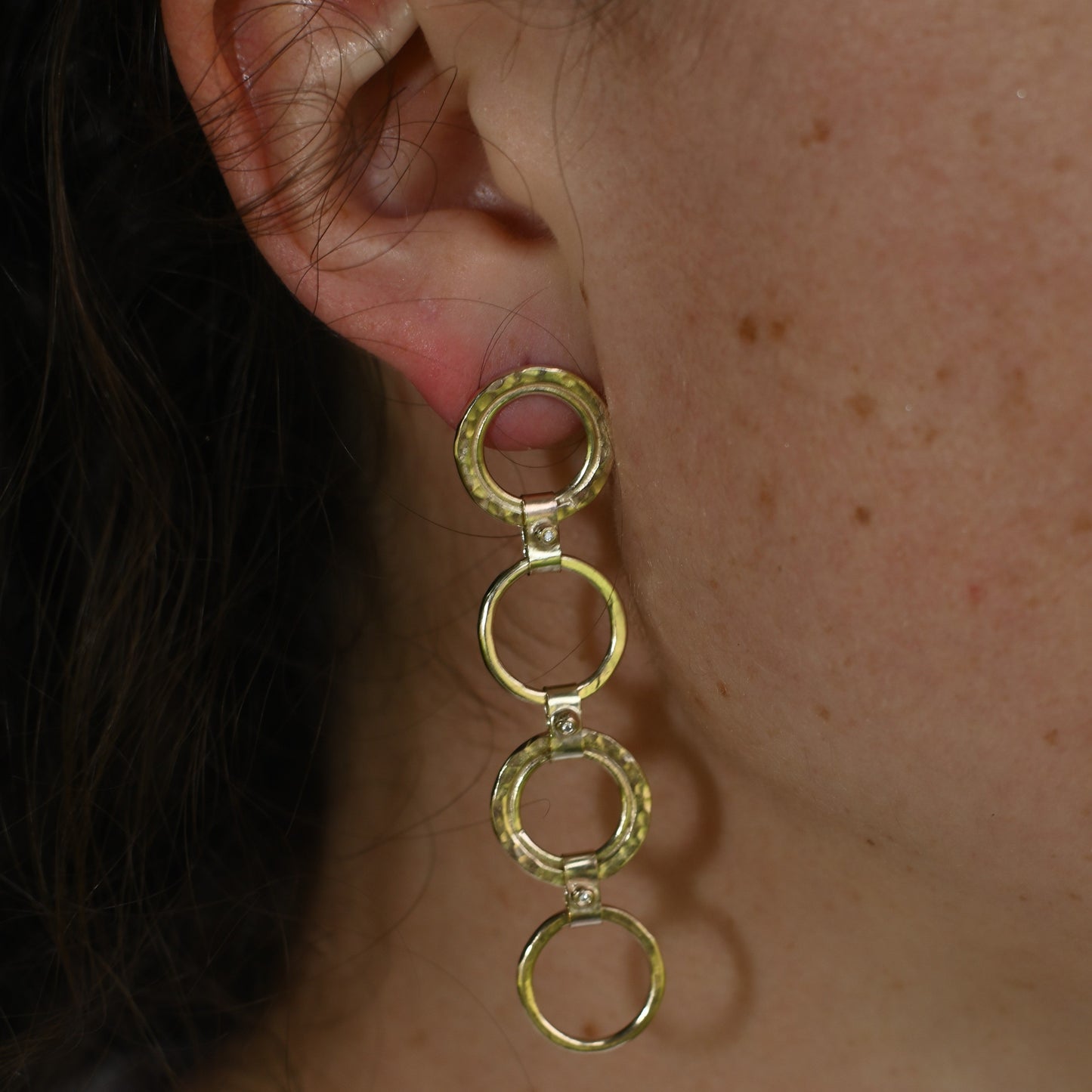 gold circle earrings with diamonds pictured on Madeleine. Handmade fine jewellery.