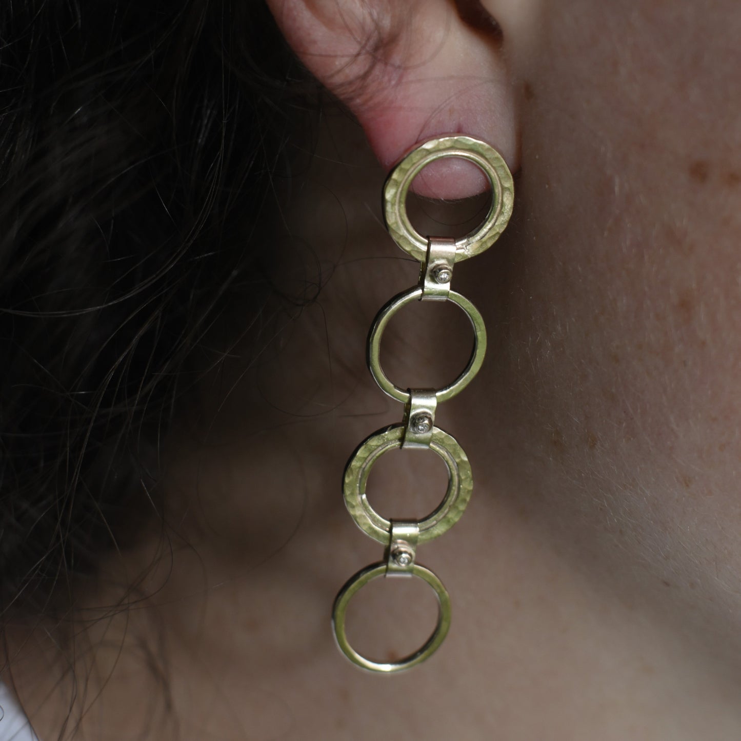 gold diamond drop earrings pictured on Madeleine. Handmade fine jewellery.