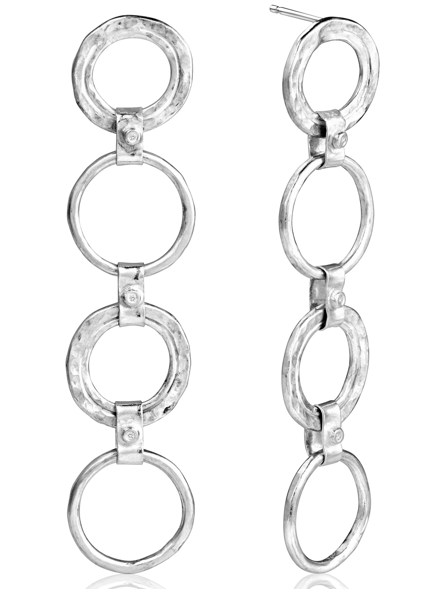 silver diamond drop earrings pictured on white.