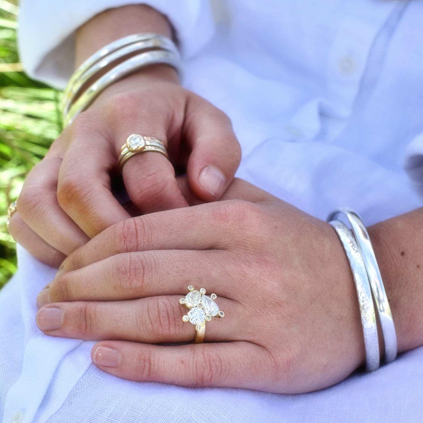 Maddy wearing chunky silver handmade bangles stacked on her wrist, photographed in the Cotswolds.
