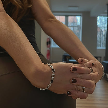 Close-up of hands with jewelry in a blurred indoor setting