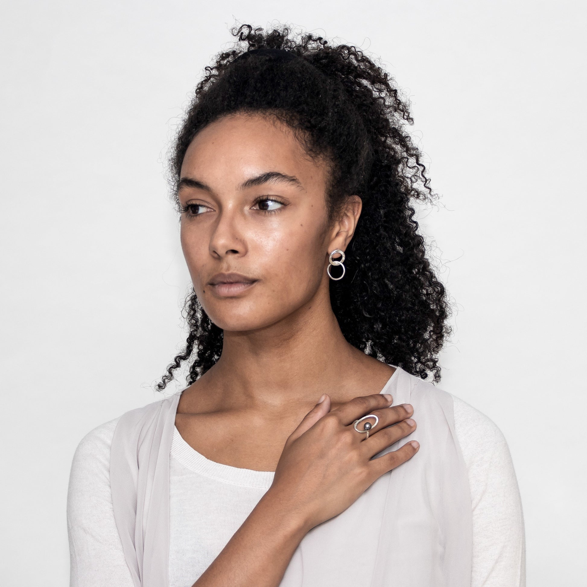 Ruby wearing sterling silver contrasting hoop earrings.