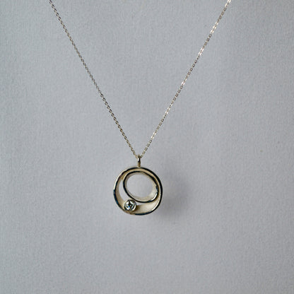 Necklace with a circular pendant on a gray background