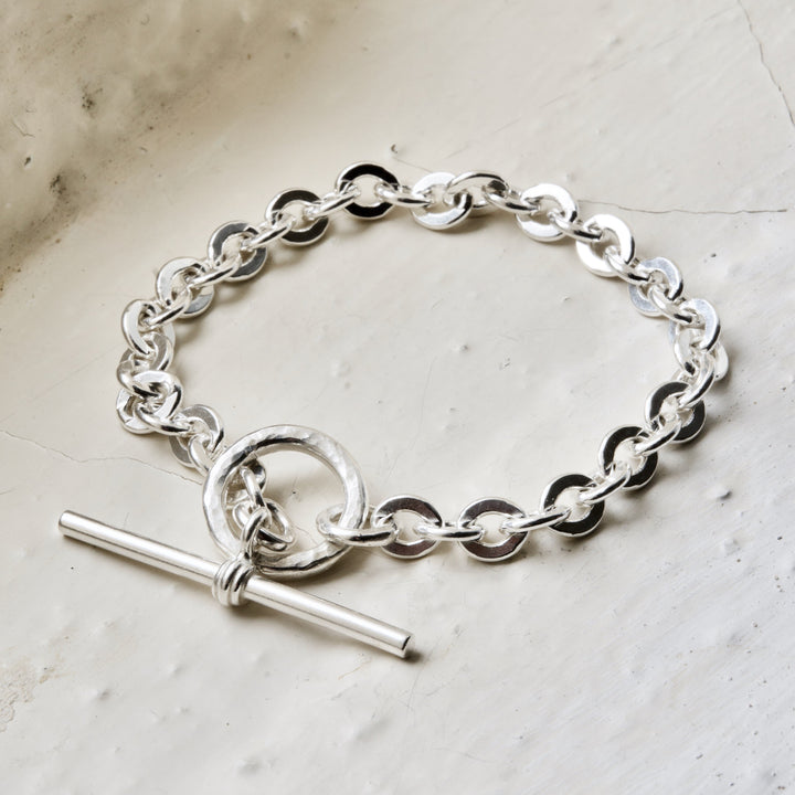 A sterling silver toggle bracelet with a double-tone clasp and interlinked chains.