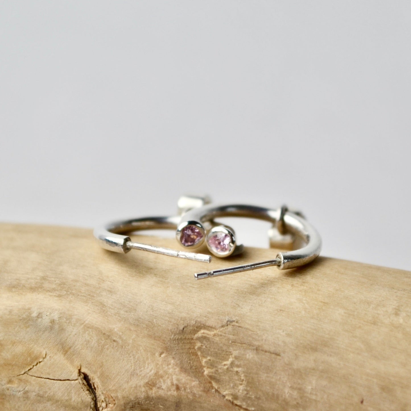 Silver ring with gemstones on a wooden surface