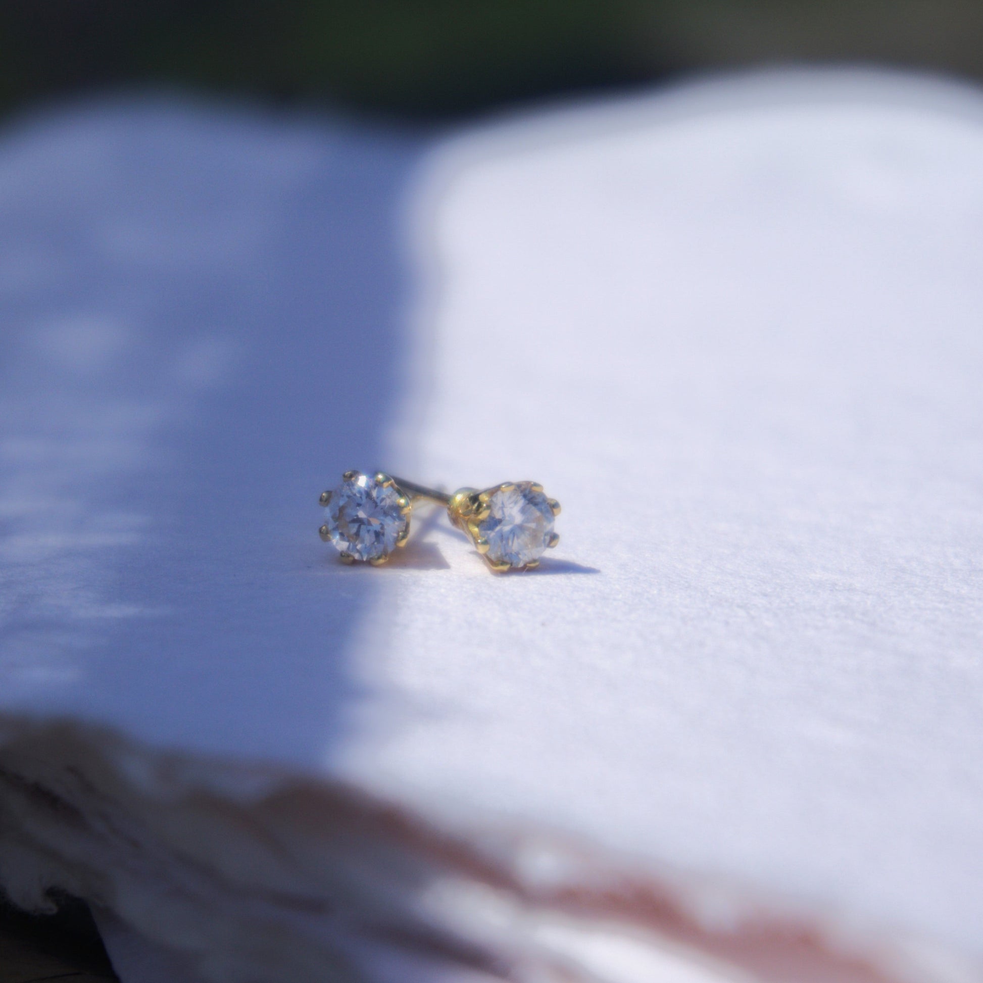 18ct yellow gold and diamond stud earrings pictured on white in The Cotswold's. Handmade fine jewellery by Madeleine.