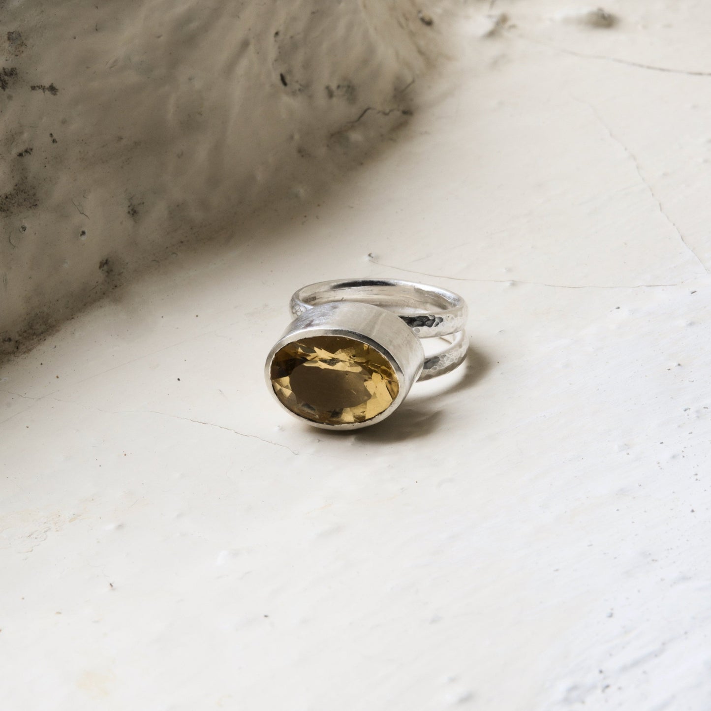 citrine and silver statement ring pictured on a white background.