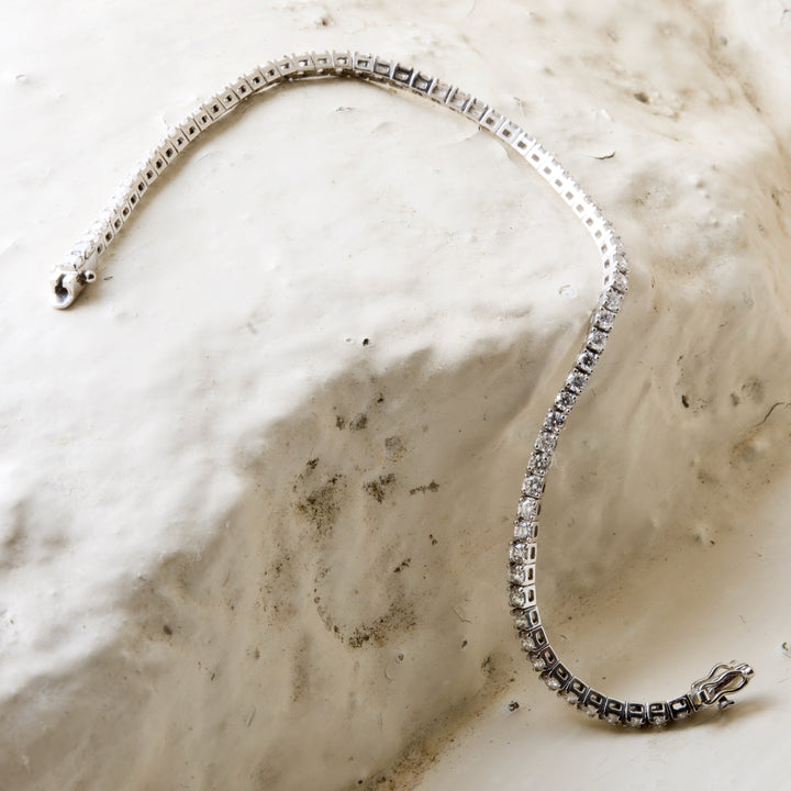 diamond tennis bracelet pictured on white brick in the Cotswold&