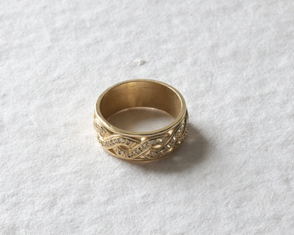 celtic diamond twist ring with diamonds pictured on white.