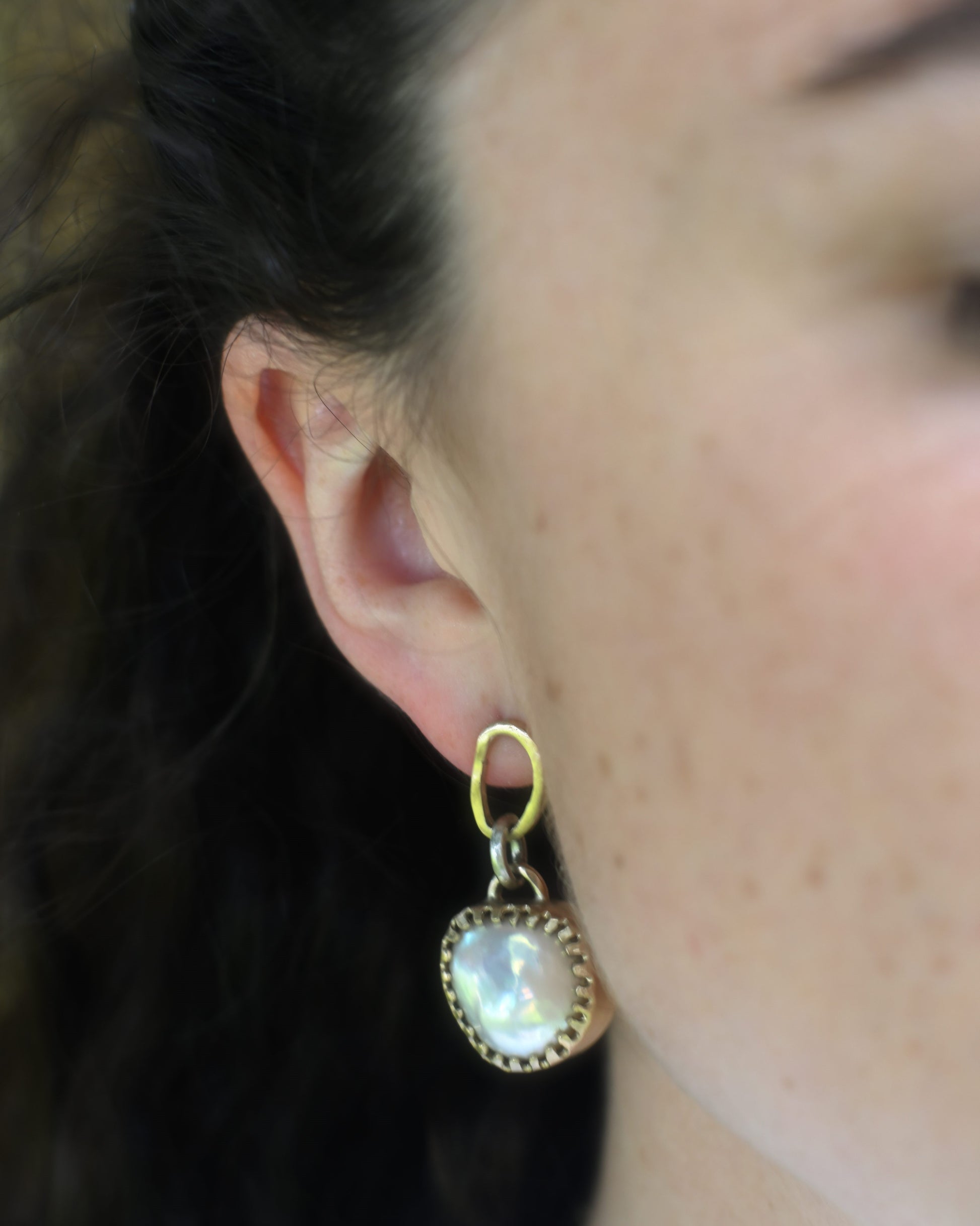 young pretty women wearing big statement pearl earrings.