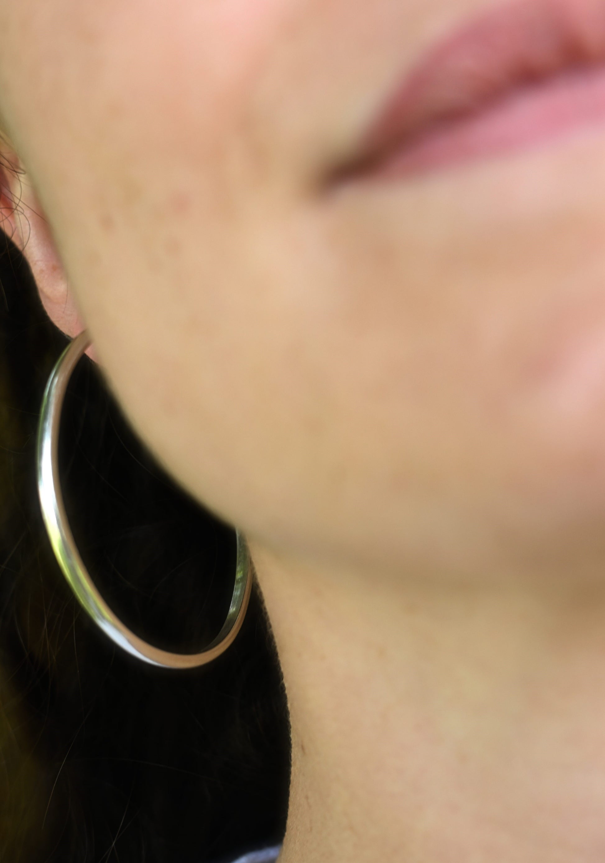Maddy wearing the classic silver hoops in the cotswolds.