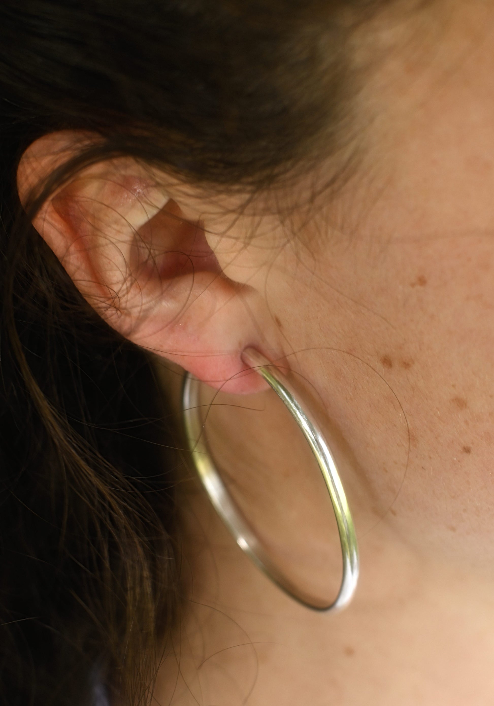 Maddy wearing the classic silver hoops.