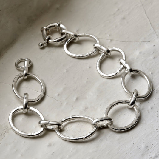sterling silver diamond bracelet pictured on white brick in the cotswolds, handmade fine jewellery by madeleine.