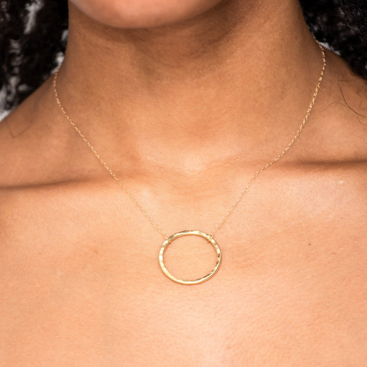 Ruby wearing the 18ct yellow circle necklace, beautifully catching the light.