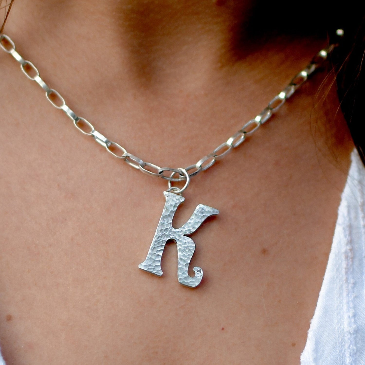 Katie wearing the diamond sterling silver letter pendant. Handmade fine jewellery by Madeleine.