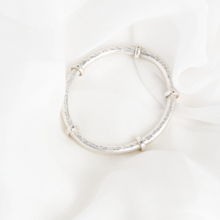 Silver hoop earring on a white background
