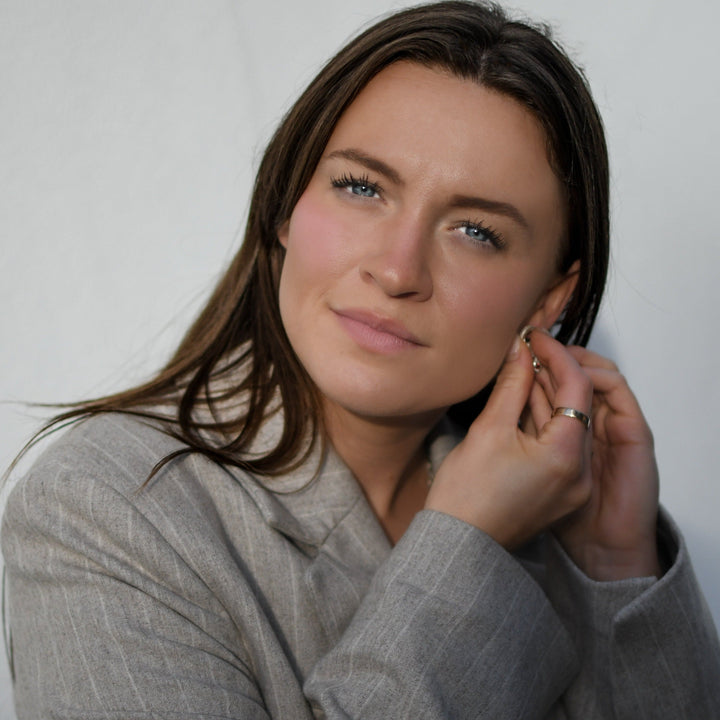 model putting on gold aquamarine drops