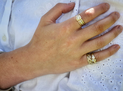 Madeleine wearing the yellow gold celtic diamond promise ring on her little finger, stacked with the scattered diamond eternity ring.