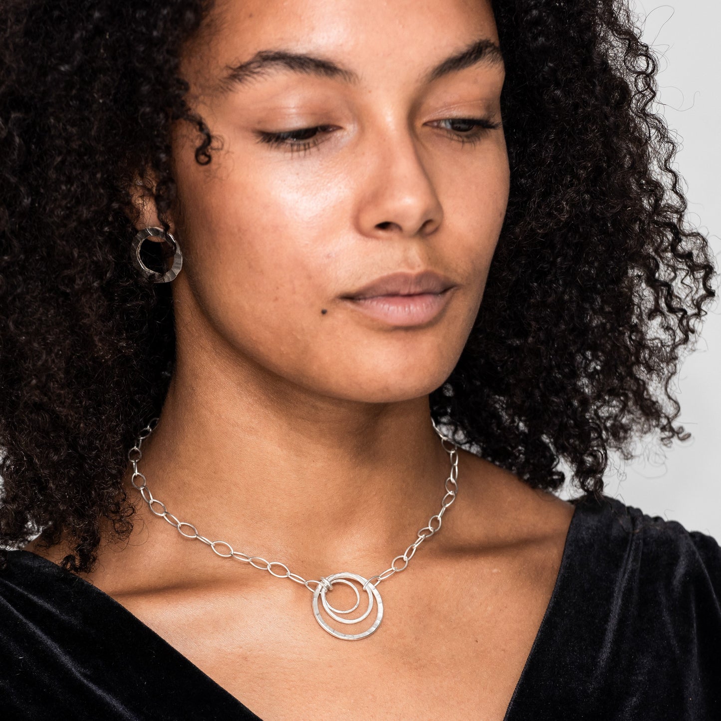 A sterling silver statement necklace modelled.